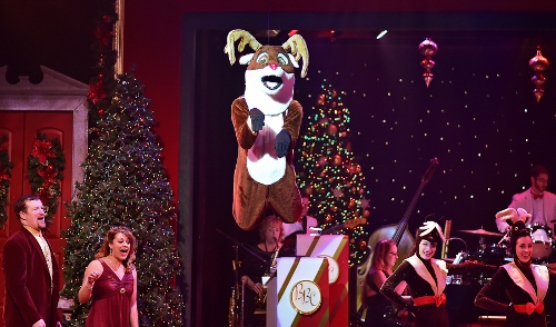 Rudolph flies overhead in A Beef & Boards Christmas, now on stage through Dec. 23.