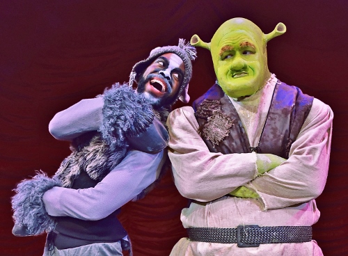 Donkey (Julius Thomas III) leaps into the arms of the ogre Shrek (Peter Scharbrough) in Beef & Boards Dinner Theatre’s premiere production of 'Shrek, The Musical.'