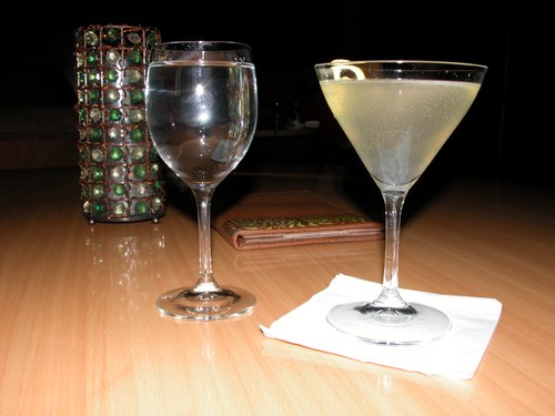 A glass of water and The Elderflower (Belvedere Vodka, Elderflower cordial, Lemon, Champagne)